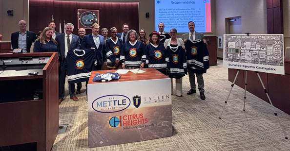 A group of people standing behind a podium
AI-generated content may be incorrect.