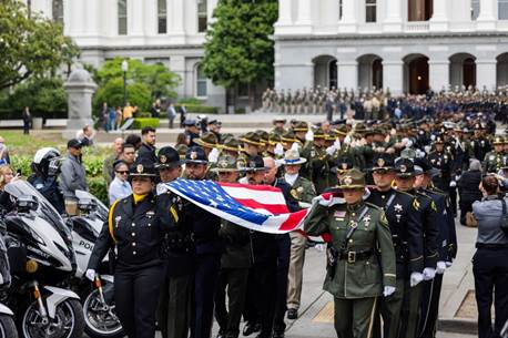 A group of people in uniform holding a flag

AI-generated content may be incorrect.